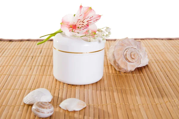 Empty cream jar on bamboo mat — Stock Photo, Image