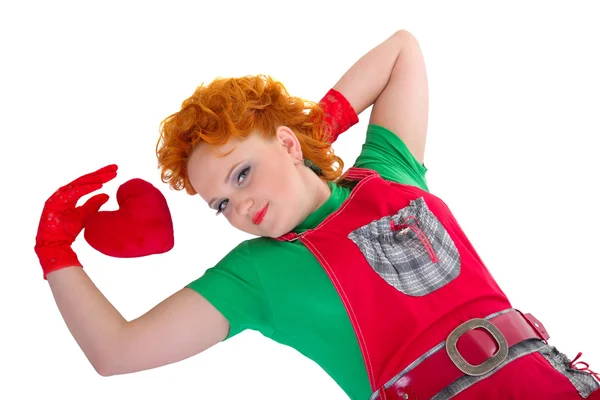 Menina bonita deitada perto de brinquedo coração, isolado — Fotografia de Stock