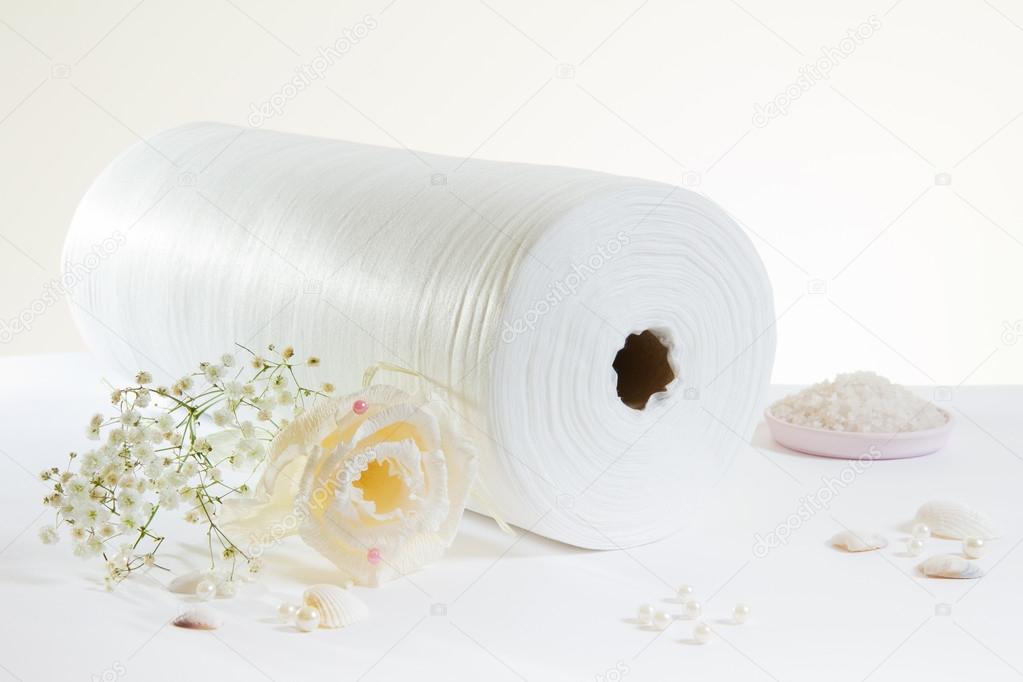 white rolled towel and salt