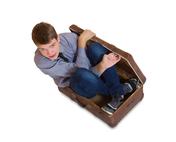 Mann sitzt in altem Koffer — Stockfoto