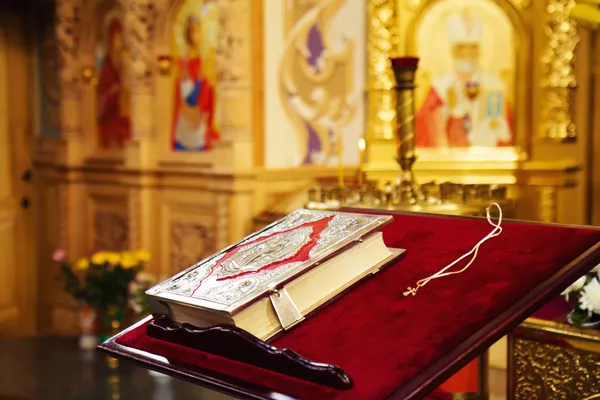 Heilige Bijbel en orthodoxe kruis in orthodoxe kerk — Stockfoto