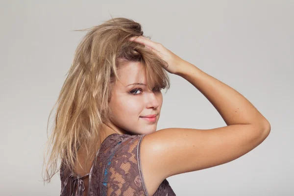 Blond woman holding hair — Stock Photo, Image