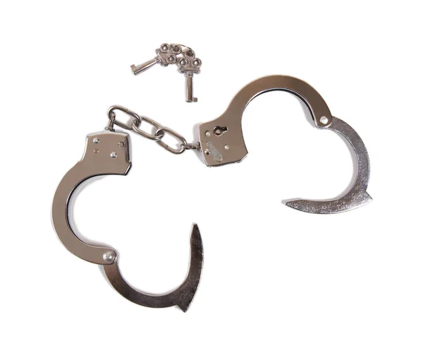 A pair of opened handcuffs with keys — Stock Photo, Image