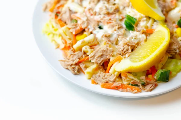 Cavatelli pasta with tuna and iceberg lettuce, carrots, sweet corn and cucumber in a sauce mayonnaise, healthy food