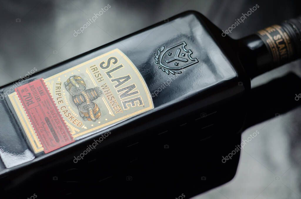 LONDON, UNITED KINGDOM - JANUARY 25, 2022 Characteristic black bottle Slane Irish whiskey, blend of grain and malt whiskeys matured in the distinctive flavours of three casks