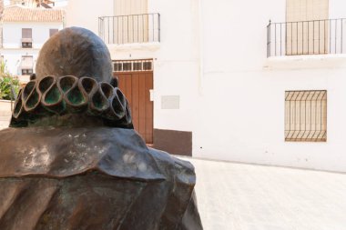 VELEZ-MALAGA, SPAIN - 17 AUGUST 2018 A sculpture of Cervantes at the entrance to the Palacio de Beniel, a 17th-century palace that now houses the Maria Zambrano Foundation and the Culture Department of the Velez-Malaga City Council