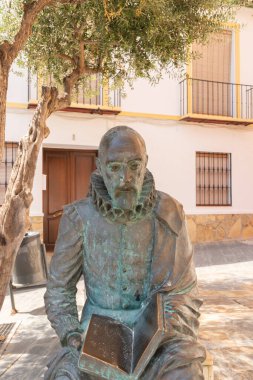 VELEZ-MALAGA, SPAIN - 17 AUGUST 2018 A sculpture of Cervantes at the entrance to the Palacio de Beniel, a 17th-century palace that now houses the Maria Zambrano Foundation and the Culture Department of the Velez-Malaga City Council