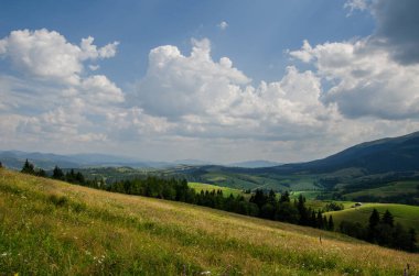 Mountain landscape. countryside landscape. beautiful views of the mountains in the summer. green trees and beautiful cloudy sky.