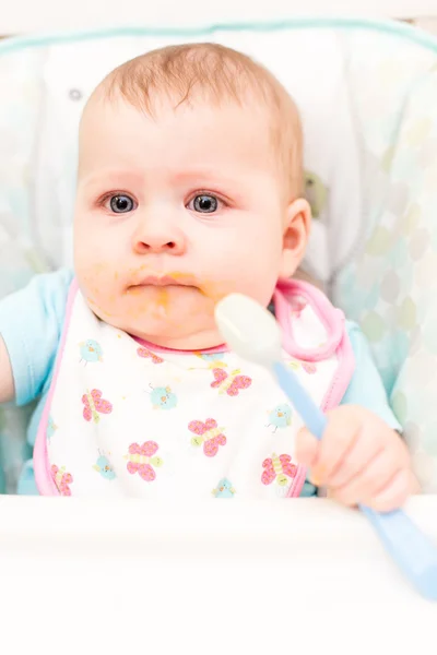 Baby girl in high chair — Stock Photo, Image