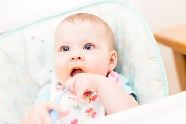 Baby girl in high chair — Stock Photo, Image
