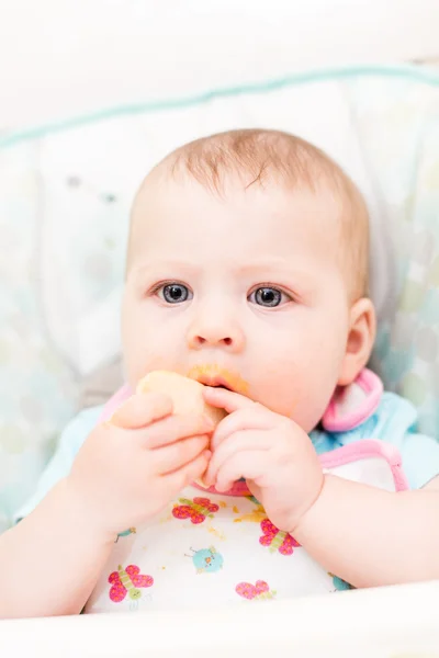 Baby girl in high chair — Stock Photo, Image