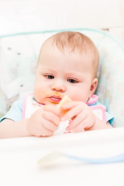 Baby girl in high chair — Stock Photo, Image