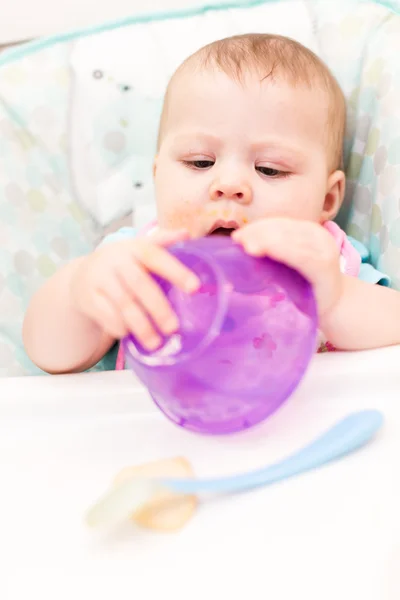 Baby girl in high chair — Stock Photo, Image