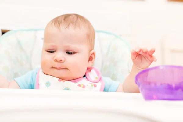 Baby girl in high chair — Stock Photo, Image