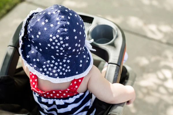 Baby girl in her stroller. — Stock Photo, Image