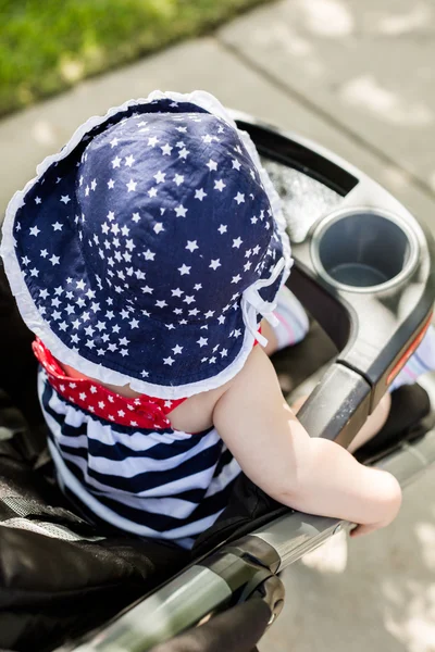 Baby girl in her stroller. — Stock Photo, Image