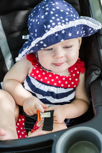 Baby girl in her stroller. — Stock Photo, Image