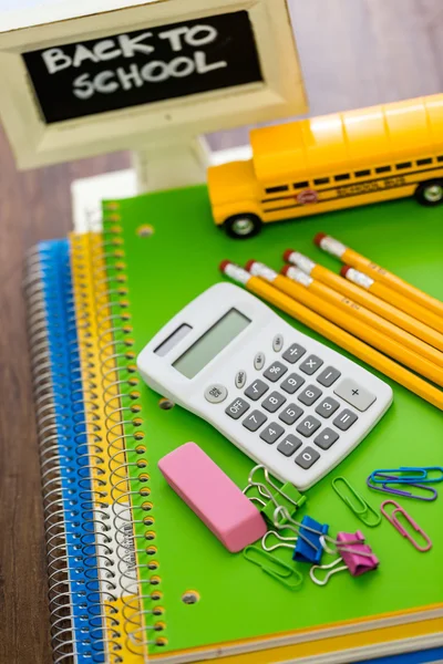 School supplies, pencils, toy school bus, note book, calculator — Stock Photo, Image