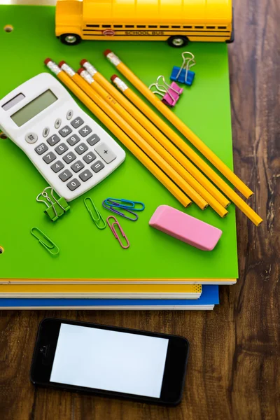 School supplies, pencils, toy school bus, note book, calculator — Stock Photo, Image