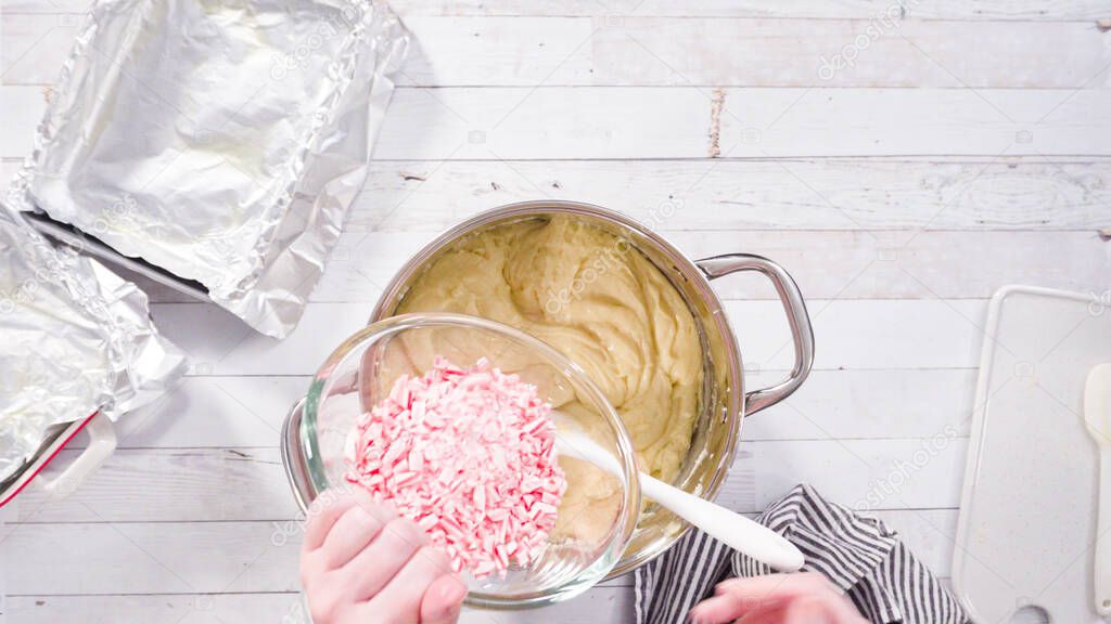 Flat lay. Step by step. Melting white chocolate chips in the cooking pot to make candy cane white chocolate fudge.