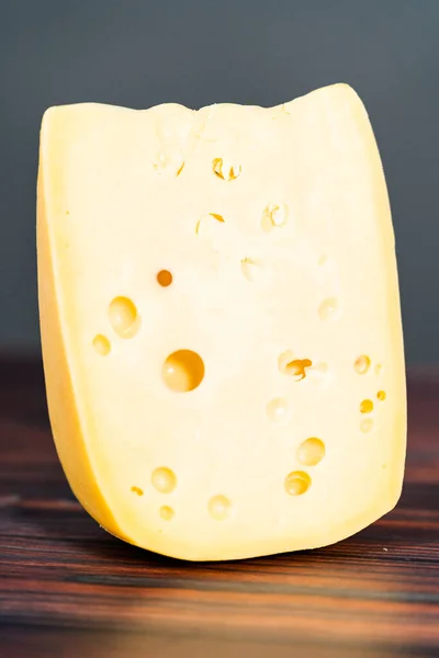 Großer Keil Aus Halbweichem Schweizer Käse Auf Dunklem Holzgrund — Stockfoto