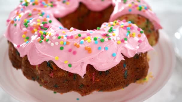Close View Sliced Funfettti Bundt Cake Pink Buttercream Frosting Top — Stock Video