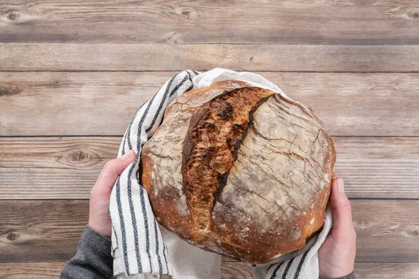 Flat lay. Freshly baked sourdough rye loaf of bread.