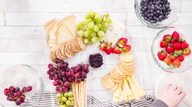 Düz yatıyordu. Adım adım. Taze meyve, gurme peynir ve kraker ile peynir tabağı hazırlıyorum..