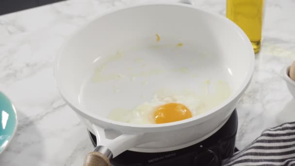白いフライパンで新鮮な卵を炒める — ストック動画
