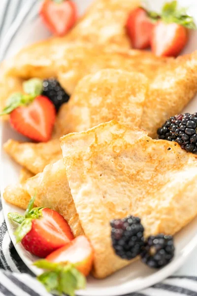 Close Freshly Baked Crepes Folded Triangles Garnished Berries Serving Plate — Stock Photo, Image