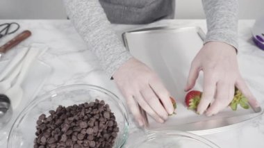 Çikolata kaplı çilekleri kurabiye tepsisinde hazırlıyorum..