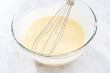 4 Temmuz pastasını çikolatalı yıldızlarla karıştırmak için cam bir kasenin içindekileri karıştırıyorum..