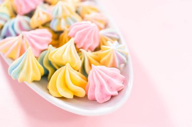 Beyaz servis tabağında çok renkli tek boynuzlu at kurabiyeleri..