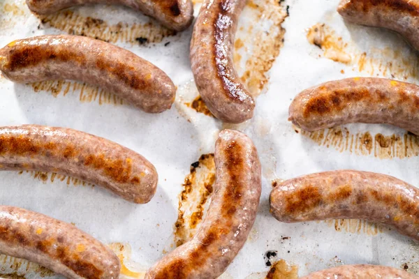 Freshly Cooked Oven Beer Bratwursts Baking Sheet Lined Parchment Paper — Stock Photo, Image