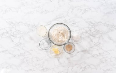 Düz yatıyordu. Akşam yemeği hazırlamak için cam karıştırma kabında ölçülmüş malzemeler..