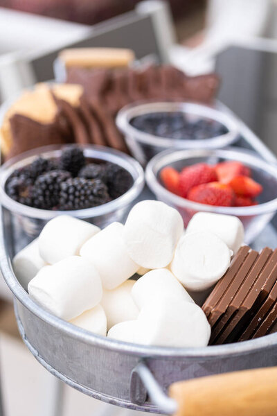 S'mores charcuterie board with fruits and star-shaped graham crakers. on the outdoor patio.