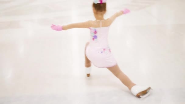 Kleines Mädchen Übt Eiskunstlauf Auf Einer Überdachten Eisbahn — Stockvideo
