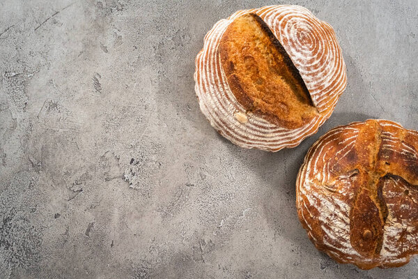 Flat lay. Freshly baked loaf of a wheat sourdough bread with marks from bread proofing basket.