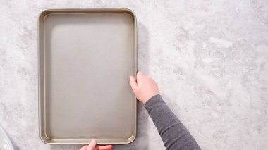 Düz yatıyordu. Adım adım. Beyaz parşömen kağıdıyla boş fırın çarşafları.