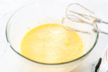 Kırmızı kadife kek ve krem peynir jöleli kek yapmak için büyük bir bardakta karıştırma malzemesi..