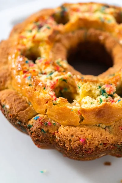 Close View Creating Holes Buttercream Filling Funfettti Bundt Cake — Stock Photo, Image
