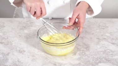 Mixing ingredients to bake eggnog bundt cake.