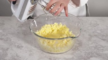 Mixing ingredients to bake eggnog bundt cake.