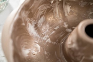 Kek pişirmek için metal tepsiyi yağlamak.