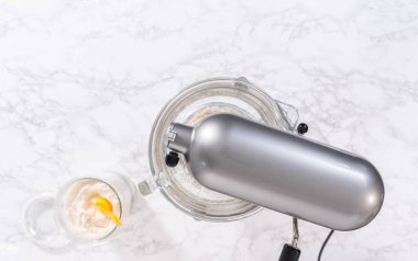 Flat lay. Mixing ingredients in a large glass mixing bowl to pizza dough.