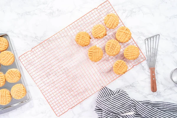 Flat lay. Freshly baked peanut butter cookies cooling on a drying rack.
