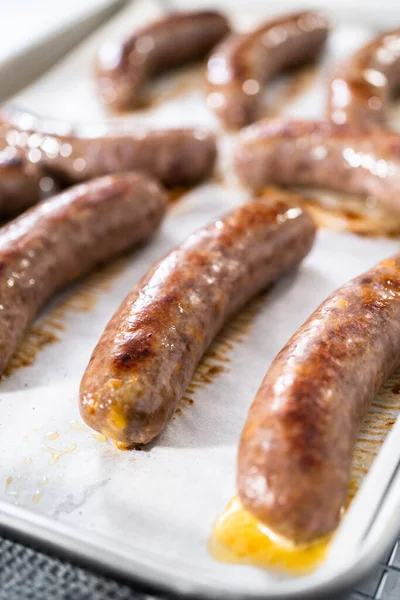 Freshly Cooked Oven Beer Bratwursts Baking Sheet Lined Parchment Paper — Stock Photo, Image