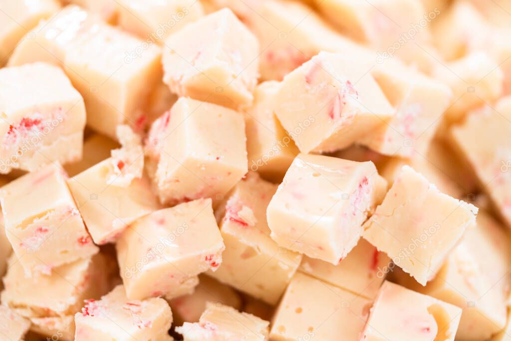Cutting candy cane fudge into small cubes.