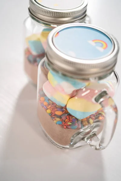 Making unicorn hot chocolate mix in drinking mason jar as a food gift.