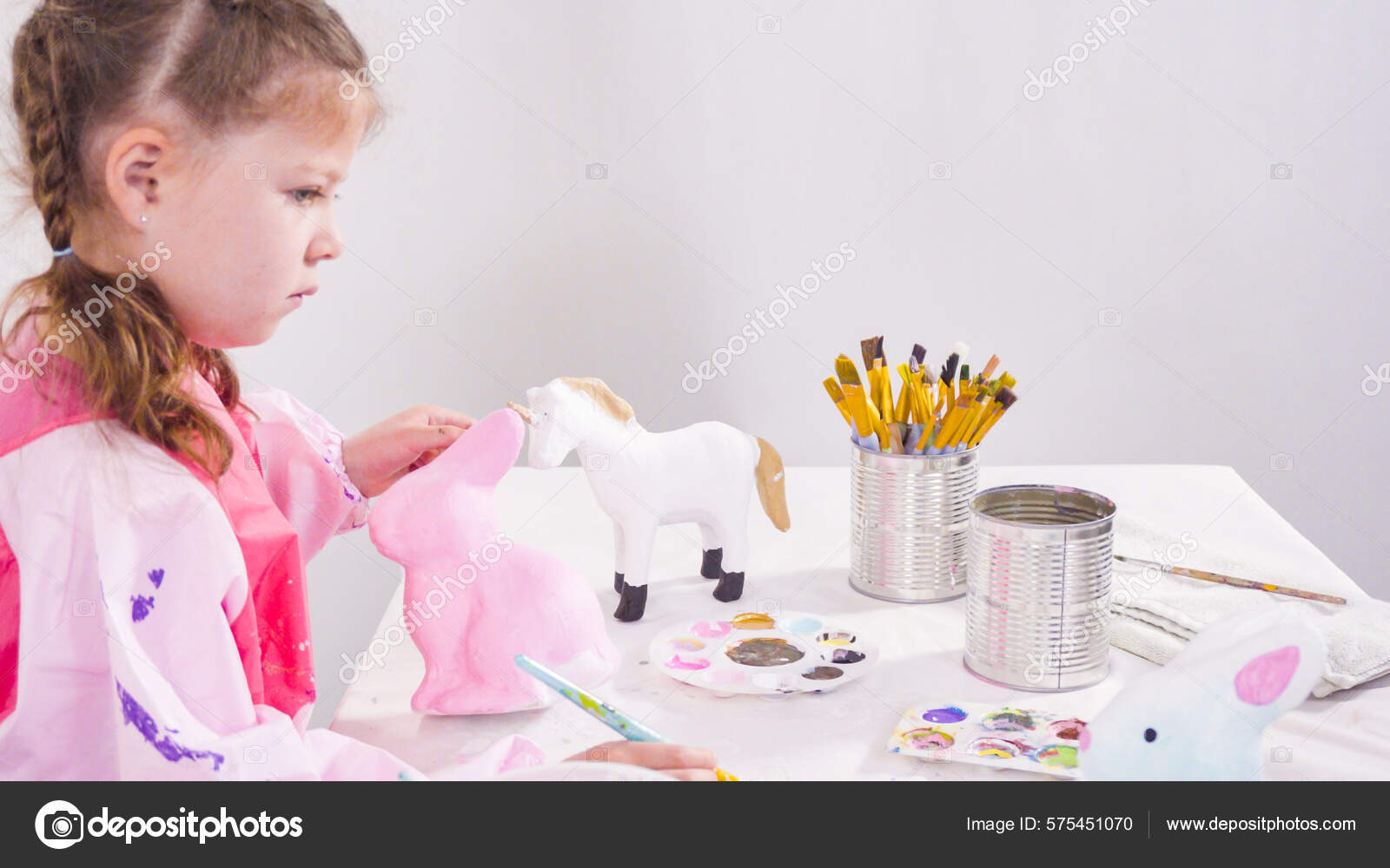 Little Girl Painting Paper Mache Figurines Acrylic Paint Her Homeschooling Stock Photo by ©urban